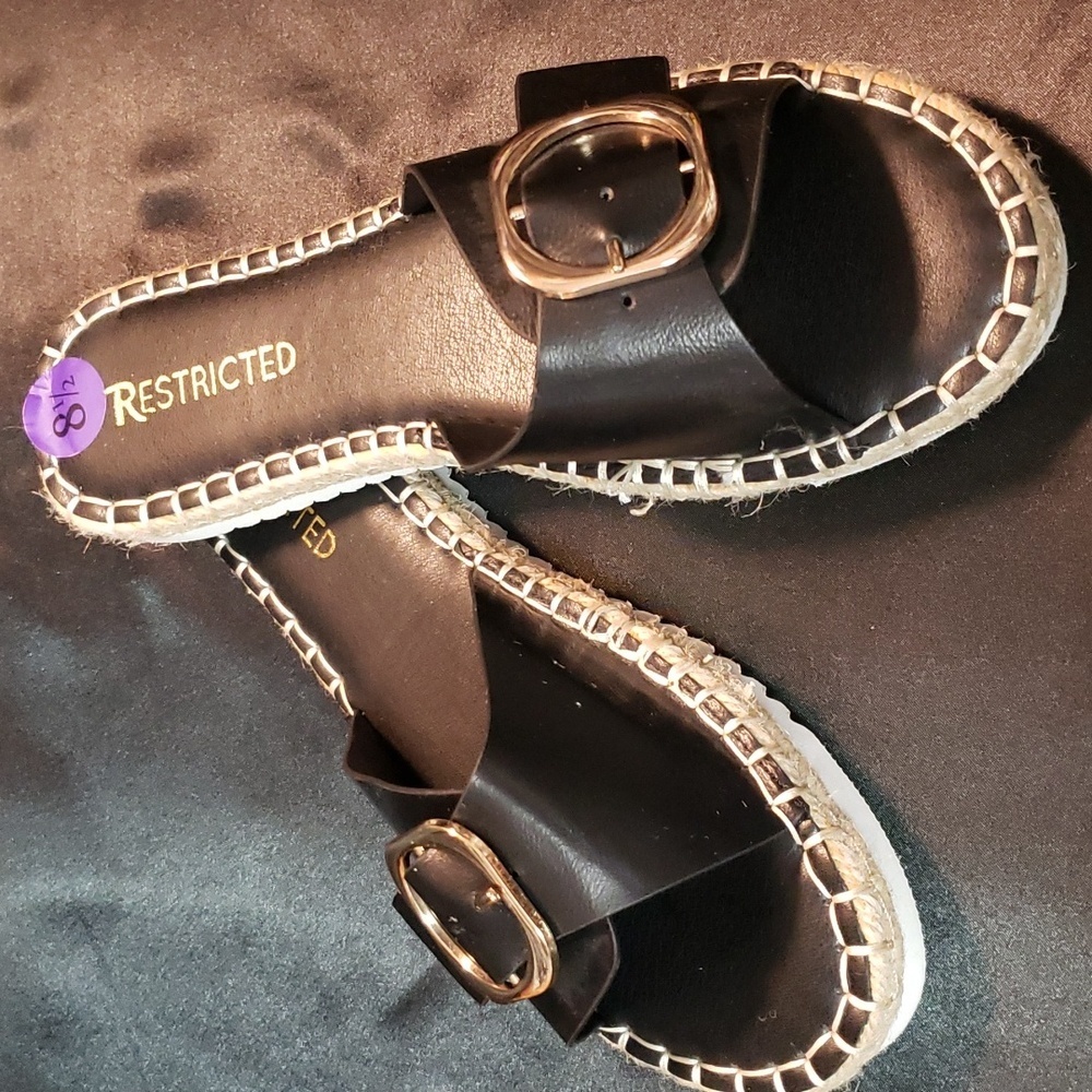 Restricted buckle trimmed black slide sandals